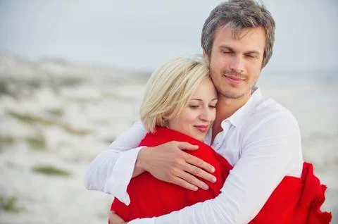 Couple embracing each other on the beach Stock Photos
