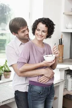 A couple embracing in the kitchen Stock Photos