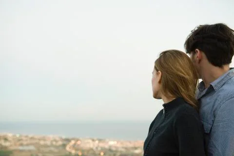 Couple embracing, looking at view Stock Photos