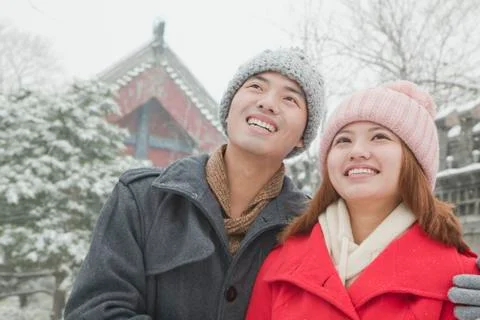 Couple embracing in snow Stock Photos