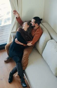 Couple Embracing on Sofa Stock Photos