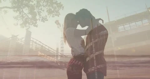 Couple embracing, sunset sparking overlaying crane and waves across faces, Stock Footage 330209345
