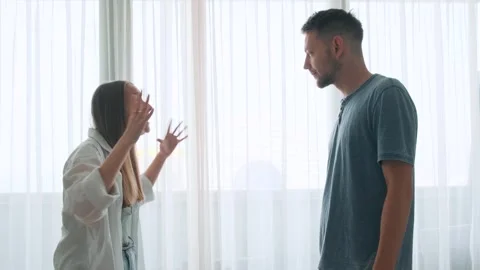 Couple engaged in serious argument inside a room. Angry worried young family Stock Footage 281588628