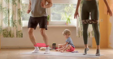 Couple is engaging in home workouts, joint exercises jumping or cardio movements Stock Footage 266750527