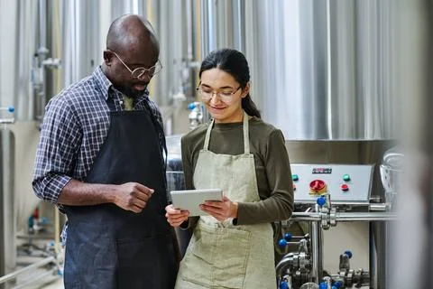 Couple of engineers using tablet pc at their work Stock Photos