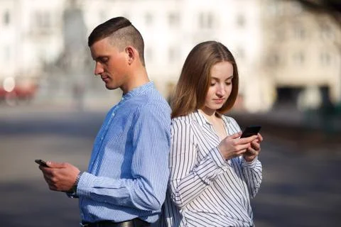 Couple engrossed in messaging Stock Photos