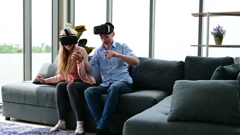 Couple enjoy  playing VR game at home. Stock-Footage 135709077