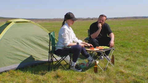 Couple enjoying barbecue picnic while camping Stock Footage 344603892