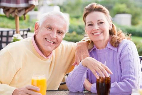 Couple enjoying a beverage by a golf course Photos
