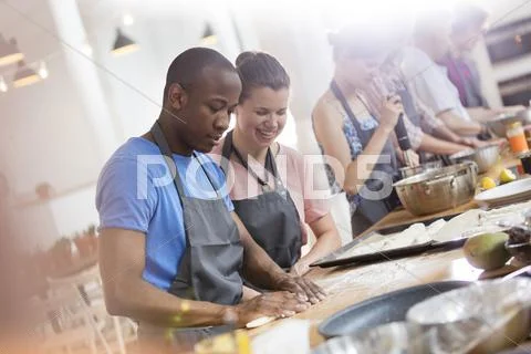 Couple enjoying cooking class in kitchen Stock Photos