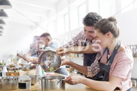 Couple enjoying cooking class in kitchen Stock Photos