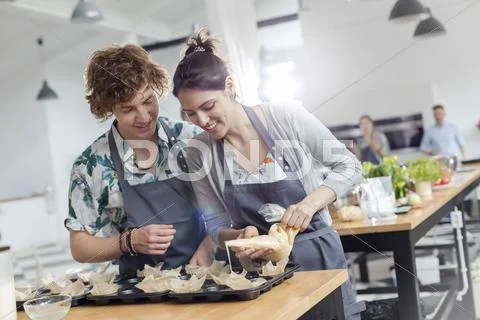 Couple enjoying cooking class in kitchen Stock Photos