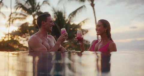 Couple Enjoying Drinks in the Pool on Vacation Stock Footage 225788247