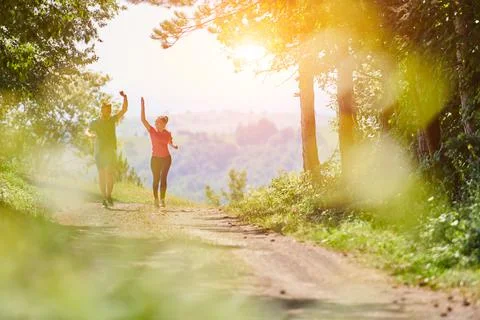 Couple enjoying in a healthy lifestyle while jogging on a country road Stock Photos