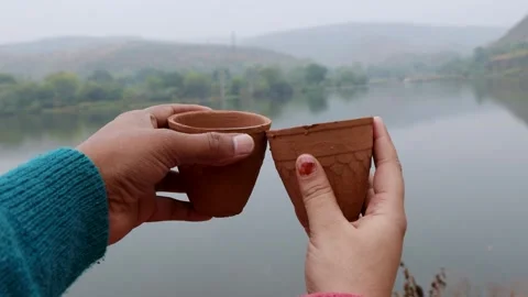 Couple enjoying hot tea served in traditional pottery clay cup with Stock Footage 282960067