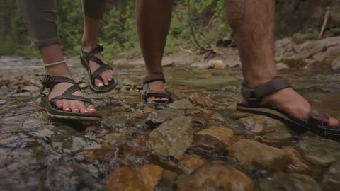 Couple enjoying leisure time while walking in stream at beautiful river Stock Footage 288616751