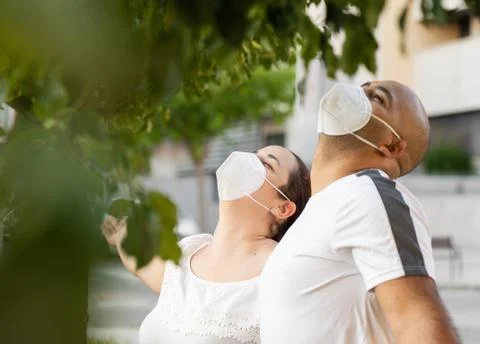 Couple enjoying the nature wearing masks Stock Photos