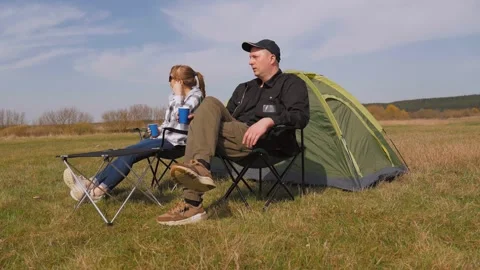 Couple enjoying a picnic while camping in nature Stock Footage 319790113