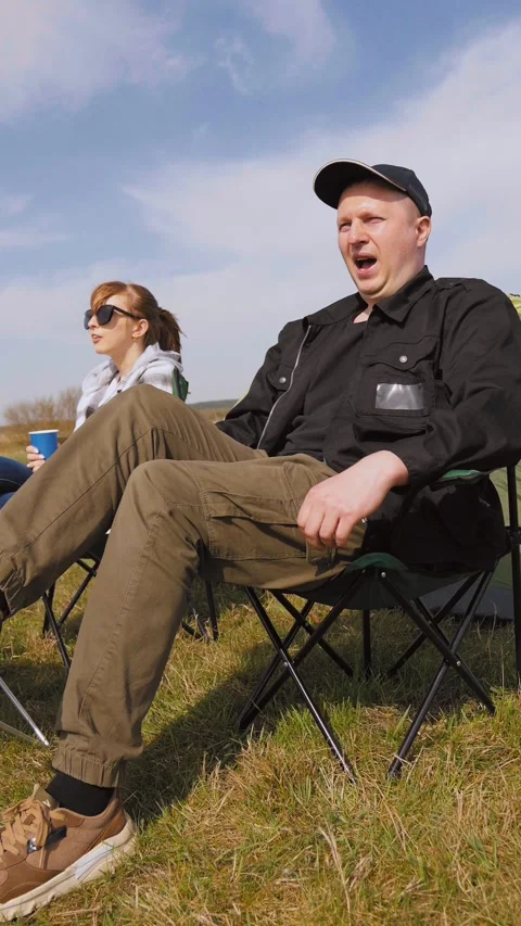 Couple enjoying a picnic while camping in nature Stock Footage 319793593