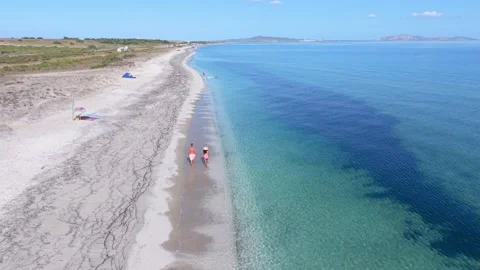 Couple enjoying a romantic getaway at Le Saline Beach in Sardinia, Italy Stock Footage 346367977