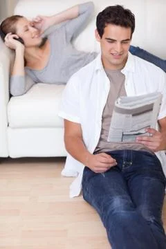 Couple enjoying their spare time in the living room Stock Photos