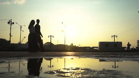 Couple enjoying the walk while talking to each other under a sunset Stock Footage 137565551