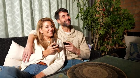 Couple enjoying wine on patio Stock Footage 303554617
