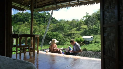 Couple enjoys nature while working and reading Vídeo Stock 307079204