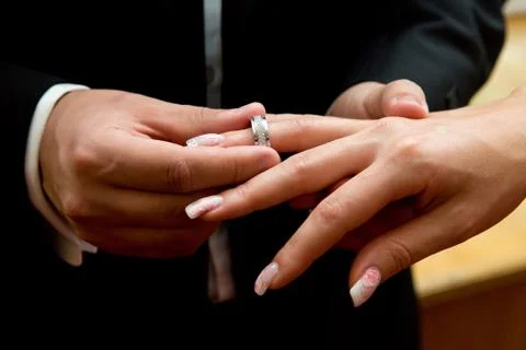 Couple exchanges rings during wedding ceremony. Stock Photos