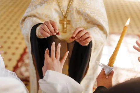Couple exchanges rings during wedding ceremony in church setting Stock Photos