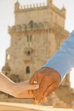 Couple exchanges rings at famous tower during sunset in city square.. couple  Stock-Fotos