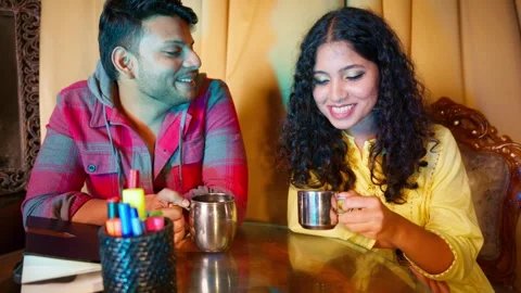 Couple exchanges warm smiles as they sit chatting Stock-Footage 297244034