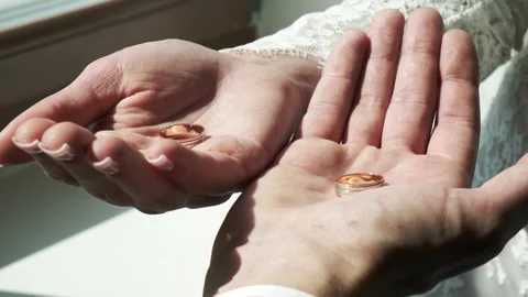 Couple exchanges wedding rings during intimate ceremony at sunny location Stock Footage 317606681