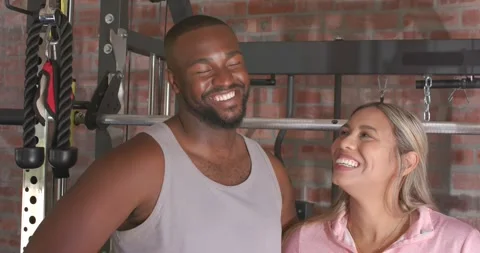 Couple exchanging eye contact after man laughing, leaning by cable rig, showing Stock Footage 335479628