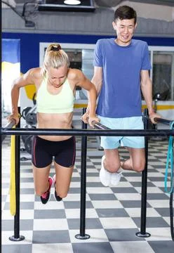 Couple exercising push-ups on bars 写真素材