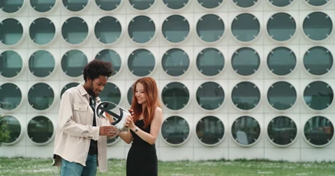A couple experimenting virtual reality in the city center Stock Footage 201114510