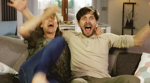Couple exploding of happiness watching soccer game on tv 4K 動画素材 68617364