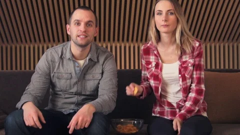 Couple exploding of happiness watching soccer game on tv Stock Footage 72476862