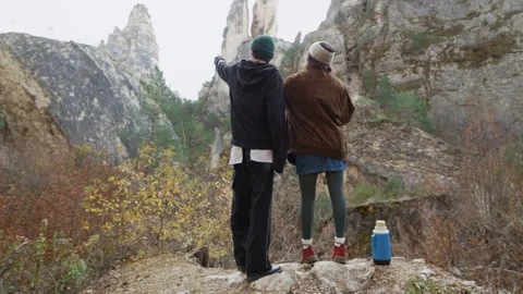 Couple Exploring Breathtaking Mountain Scenery at Sunrise Stock Footage 302211784