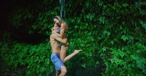 Couple Exploring Jungle Waterfall Stock Footage 83039403