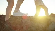 Couple Exploring A Rocky Coastal Point In Morning Sunlight Stock Footage