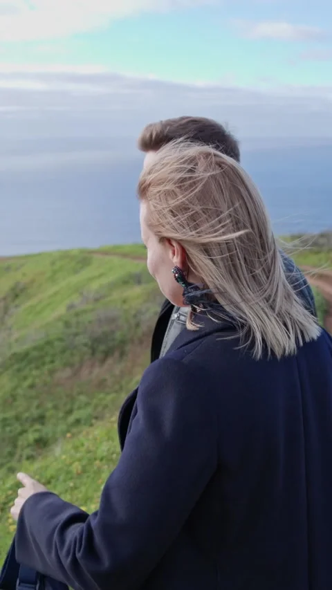 Couple exploring scenic coastal cliffs on hiking trip Stock Footage 327032965