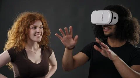 Couple exploring virtual reality together interacting with metaverse Stock Photos