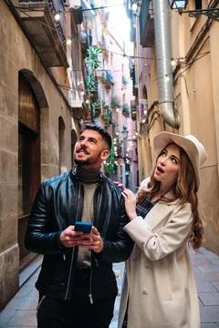 Couple expressing surprise while visiting a city Stock Photos