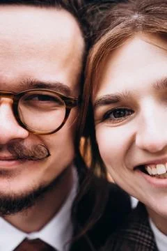 Couple faces close up with smiling man in glasses and happy woman. Extreme .. Foto stock