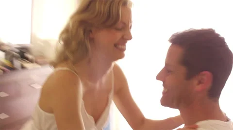 Couple falling on bed and cuddling. Stock Footage 43648692