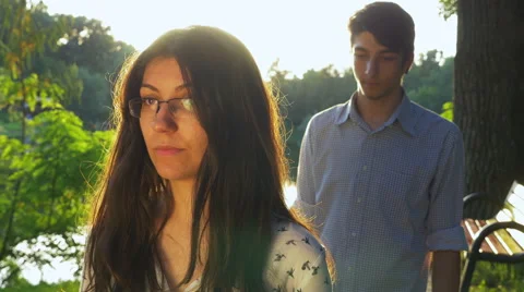 Couple feeling distant after a fight at sunset in the park Stock Footage 64861157