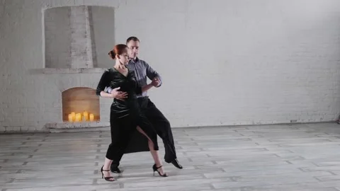 Couple in festive clothes dances passionate tango in room Stock Footage 135954792