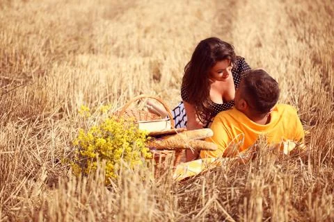 Couple in the fields having picnik Stock Photos