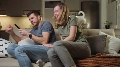 Couple fighting for tv remote control Stock Footage 167763392